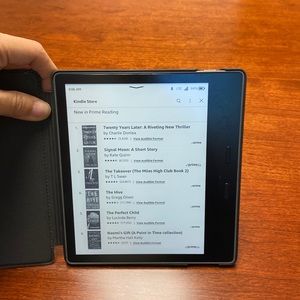 Kindle Oasis with leather-like case. Like new. 32GB, wifi + cellular